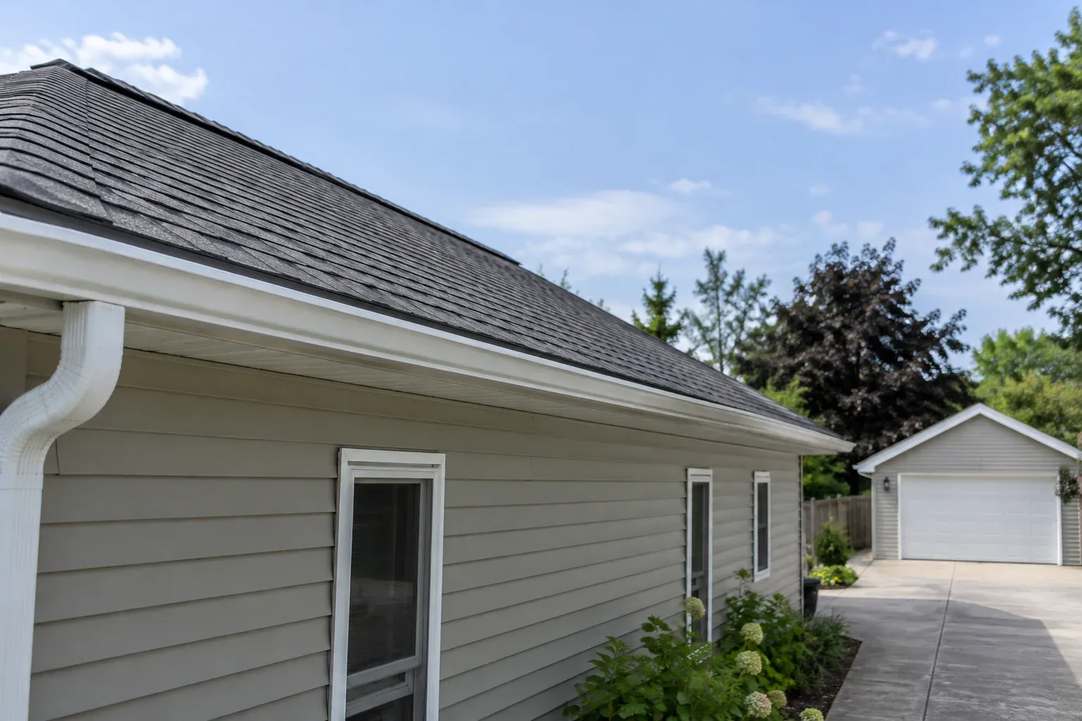 Illustrative pitched roof showing the ridge line, soffit and gutter along the eave.